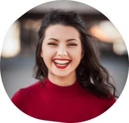 Female wearing a red sweater smiling 